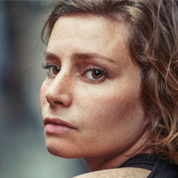 Before circular cropping: creative artist in busy art studio with paintbrushes and canvas background