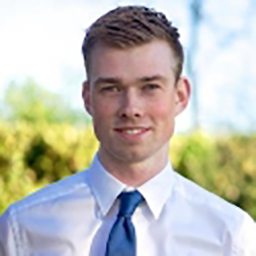 Before circular cropping: executive businessman in full office setting with distracting background elements